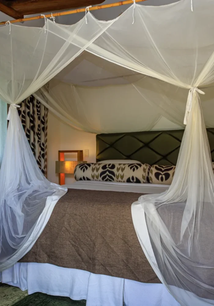 Quarto do Campo Bahia Hotel Villas Spa com sala de estar integrada e poltronas de vime